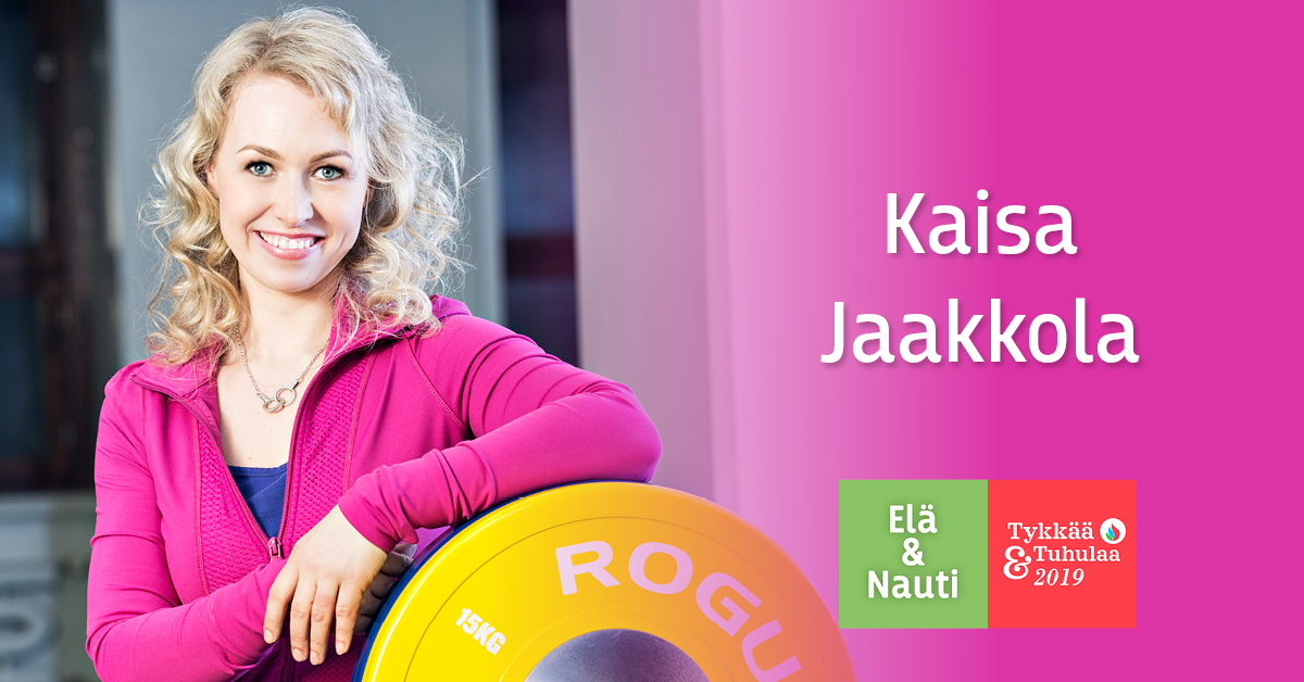 Kaisa Jaakkola pinkki huppari päällään leveästi hymyillen nojaa levypainoon vieressään Elä & Nauti | Tykkää & Tuhulaa logo